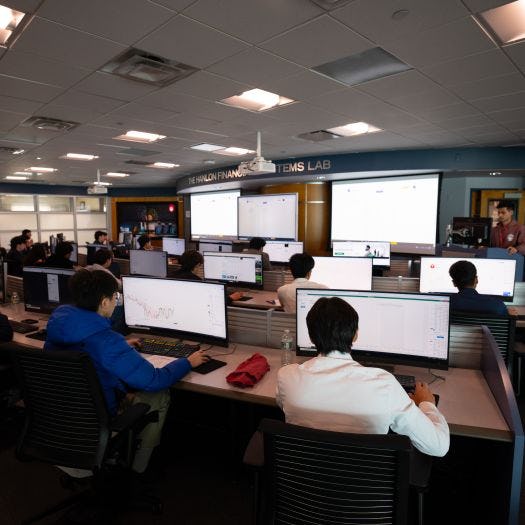 Participants in the trading day competition sit in front of their computer terminals inside the Hanlon Financial Systems Lab.