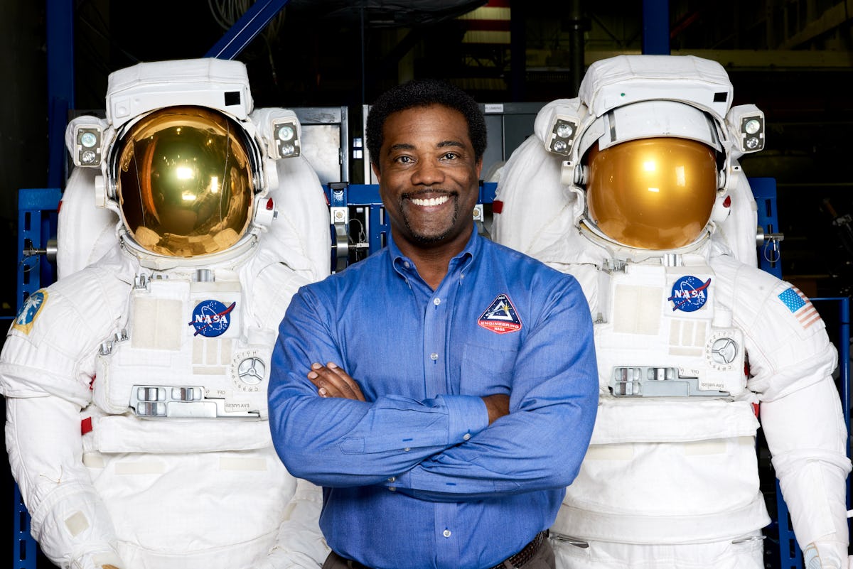 Ron Cobbs smile for the camera between two space suits.
