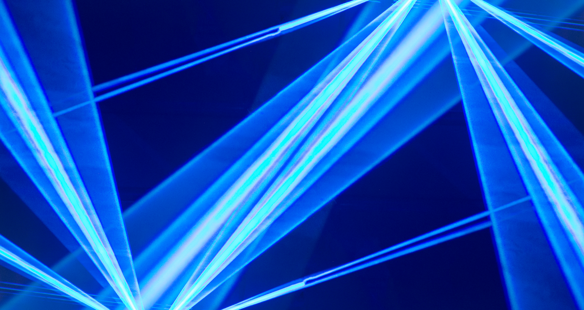 Artistic, geometric representation of lasers pointing in blue color
