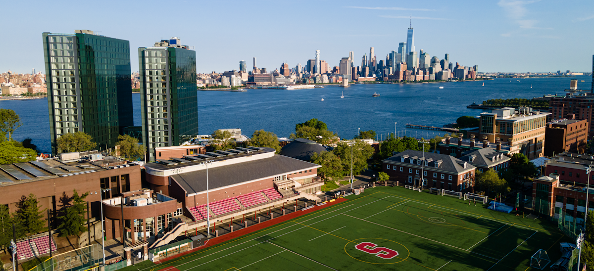 Aerial photo of the Stevens campus with the Manhattan skyline in the background