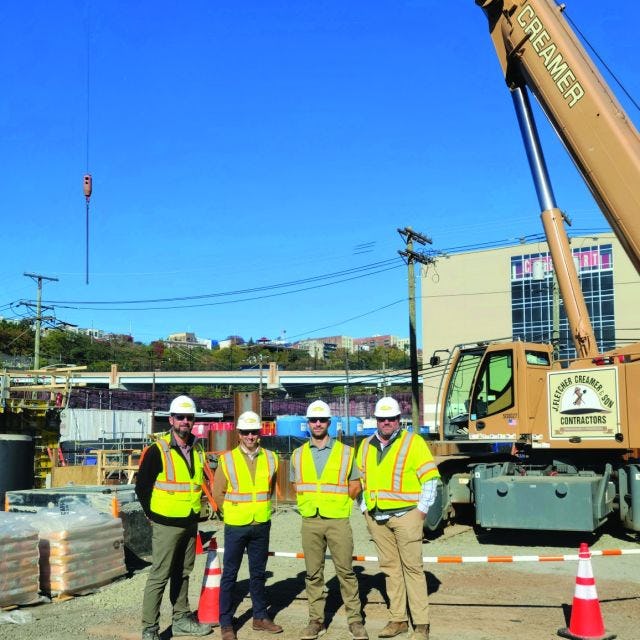 Downs and three other men at a construction site