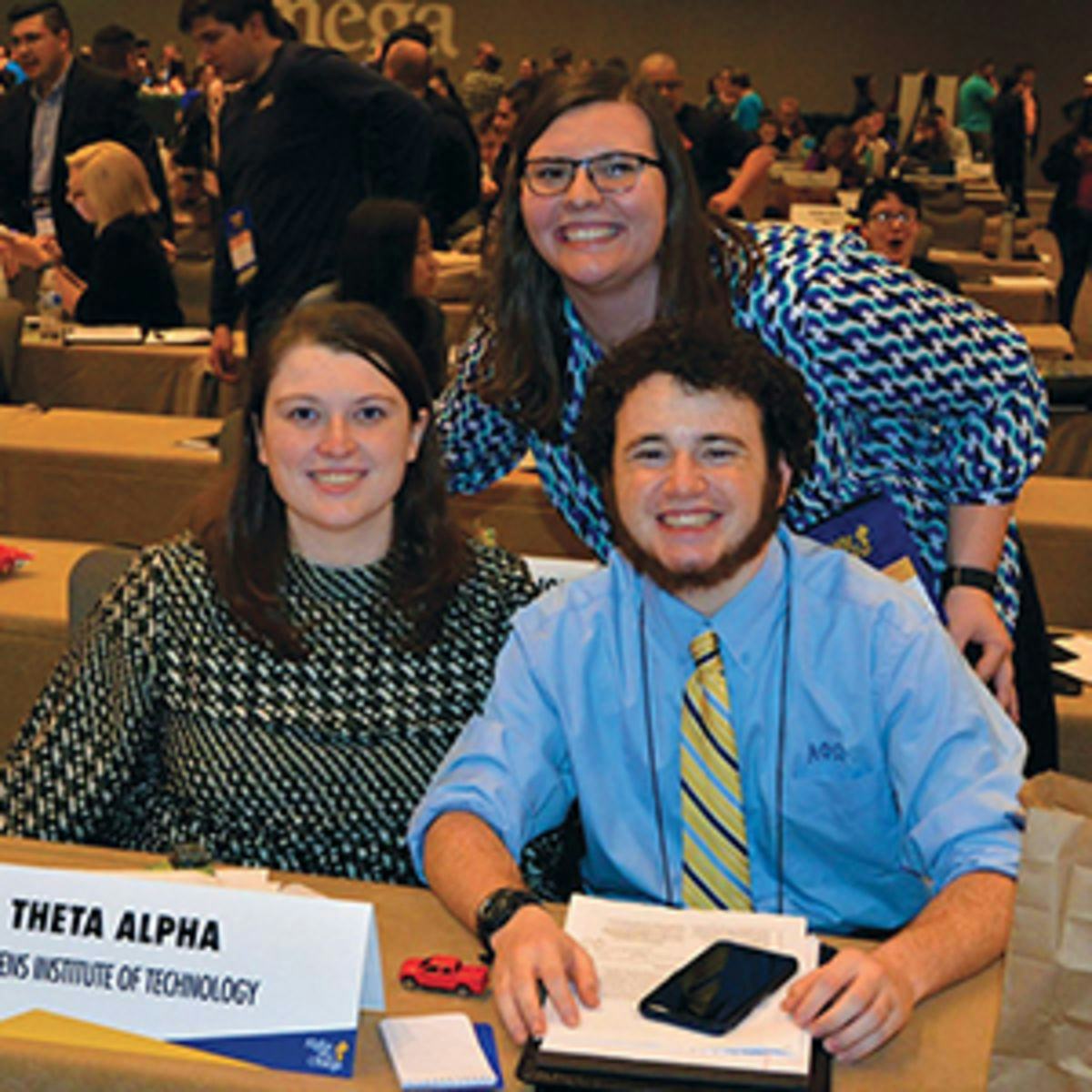 Then-undergraduates Maggie Guilfoyle ’20 (left), Luke Langner ’20 M. Eng. ’21 (right) and Katie Brown ’17 M.Eng. ’18 (standing) at the 2018 Alpha Phi Omega National Convention.