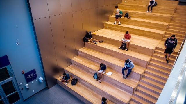 Students sitting on Gallery stairs