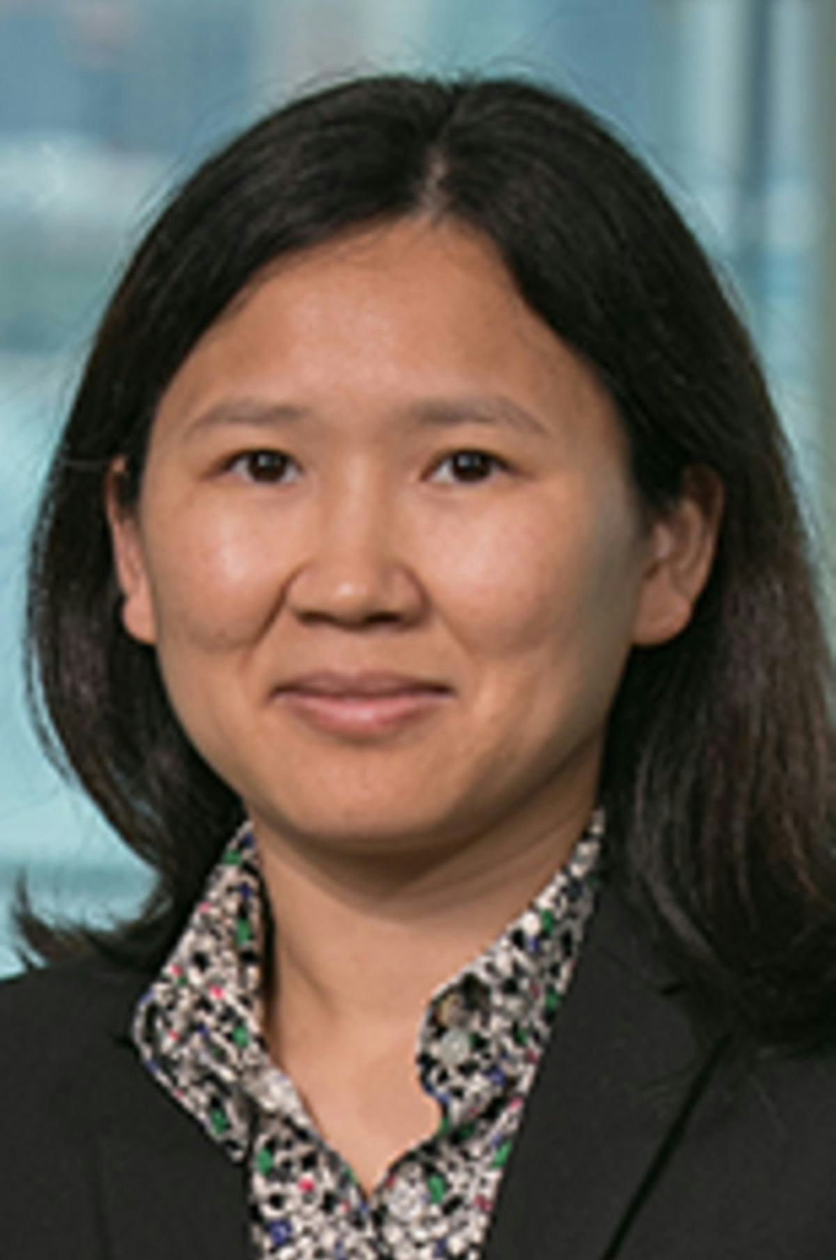 Headshot of Dr. Emily Liu with the New York City skyline in the background.