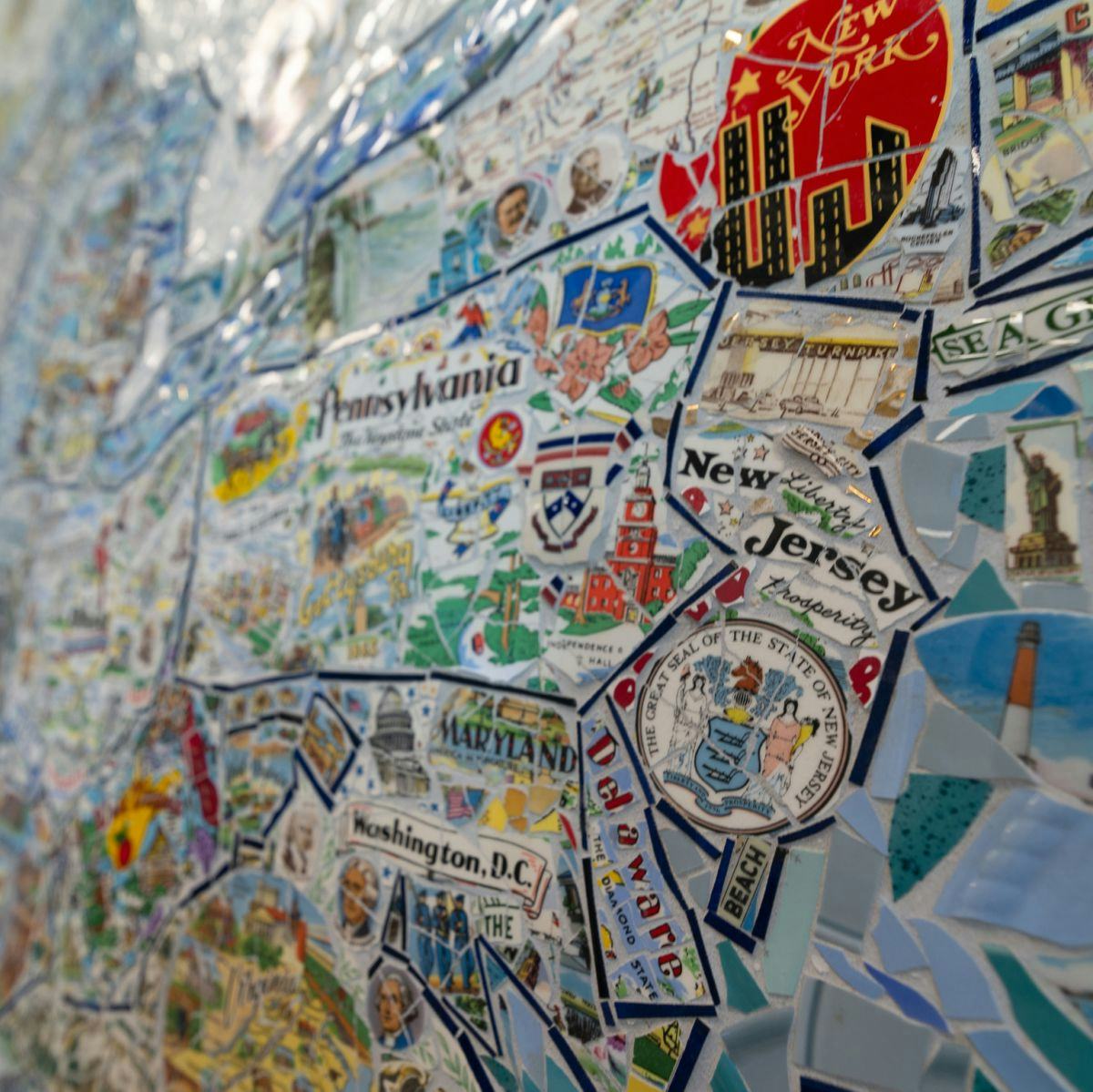 Mosaic of broken plates formed into an american map with a focus on New Jersey.