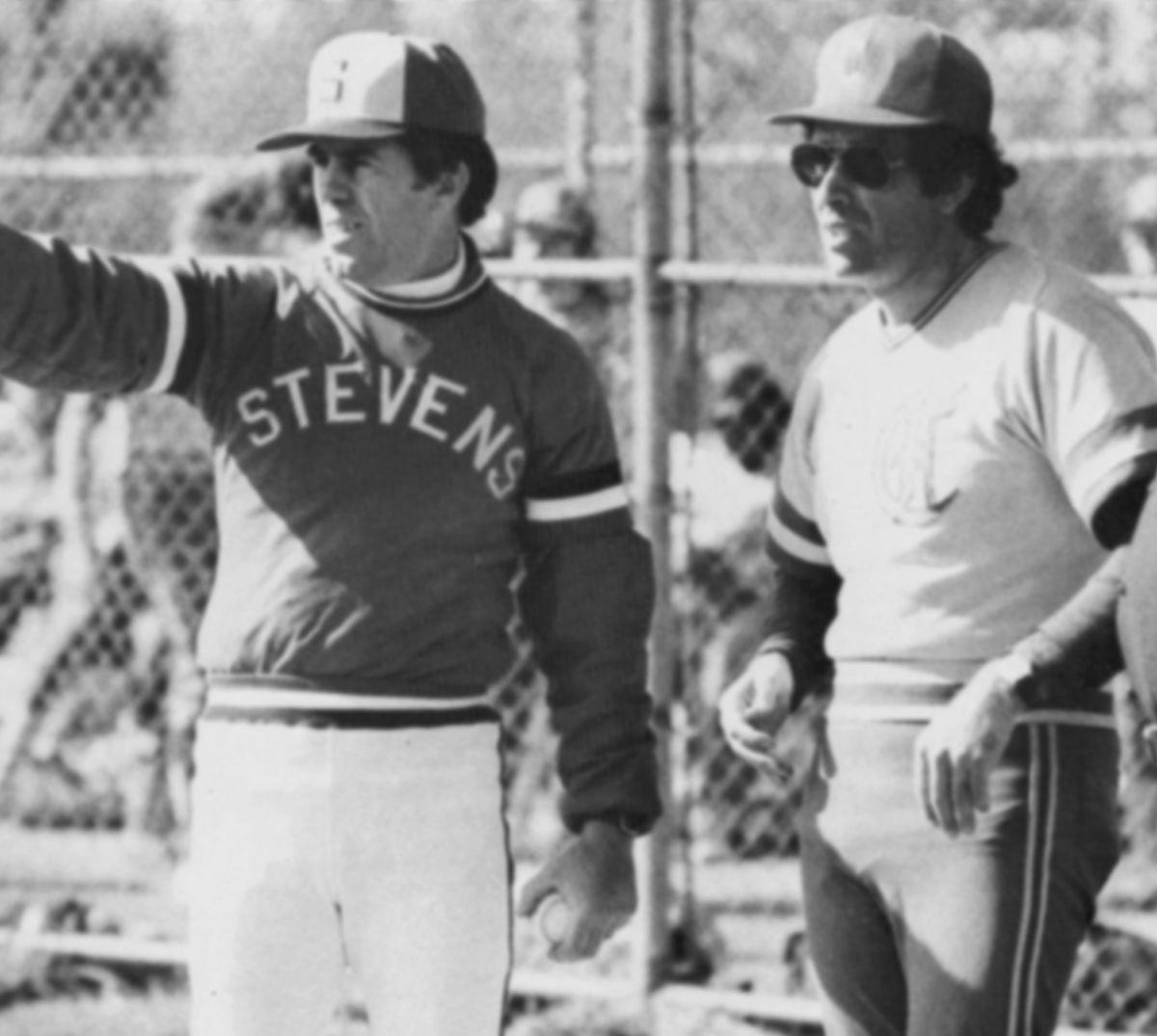 Two baseball coaches on the field in the 1980s.