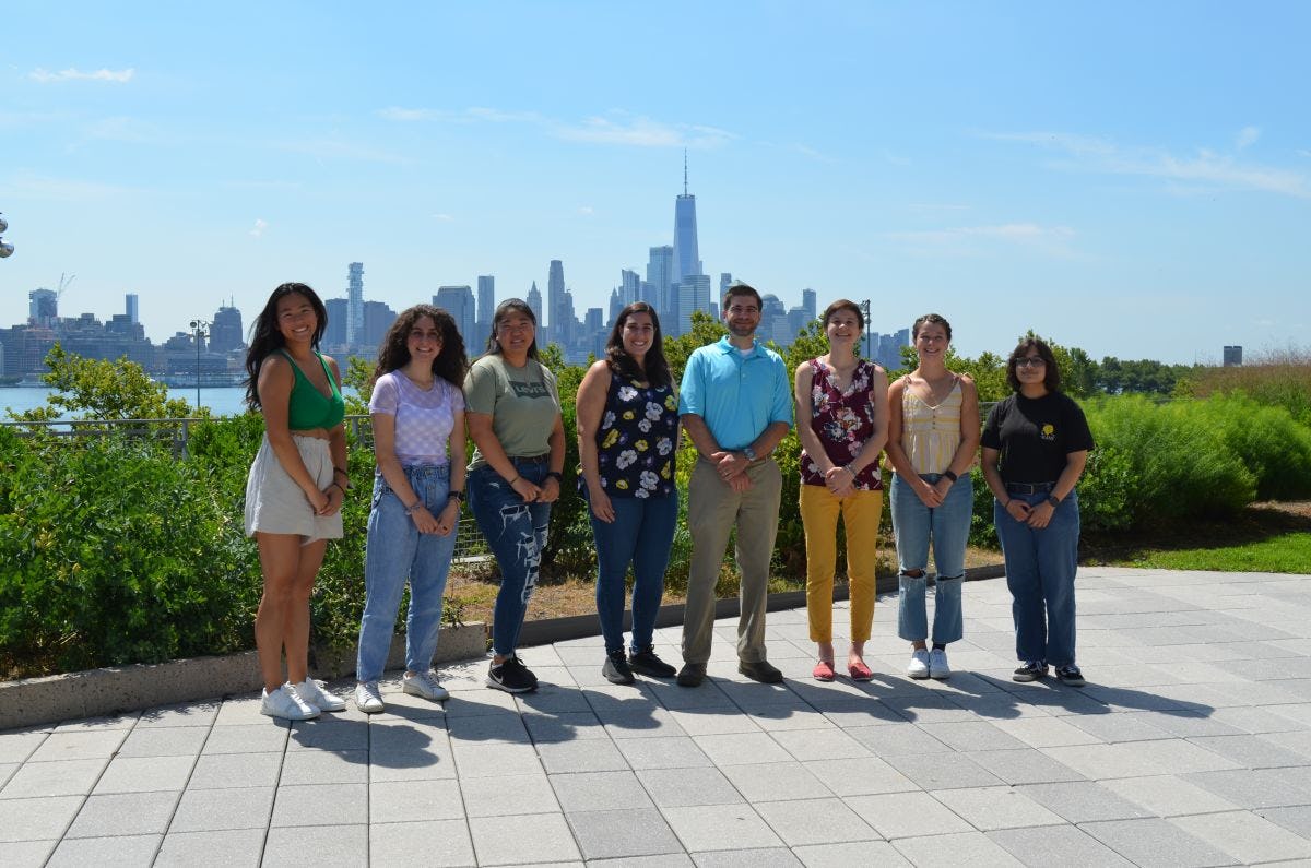 A photo of the members of George McConnell's laboratory, with the Manhattan skyline behind them