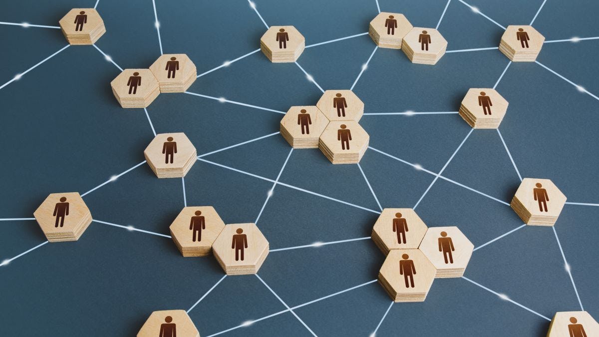 Graphic of wooden disks with people icons connected by lines. Interactions between employees and working groups. Social business connections. Networking communication. Decentralized hierarchical system of company. Organization