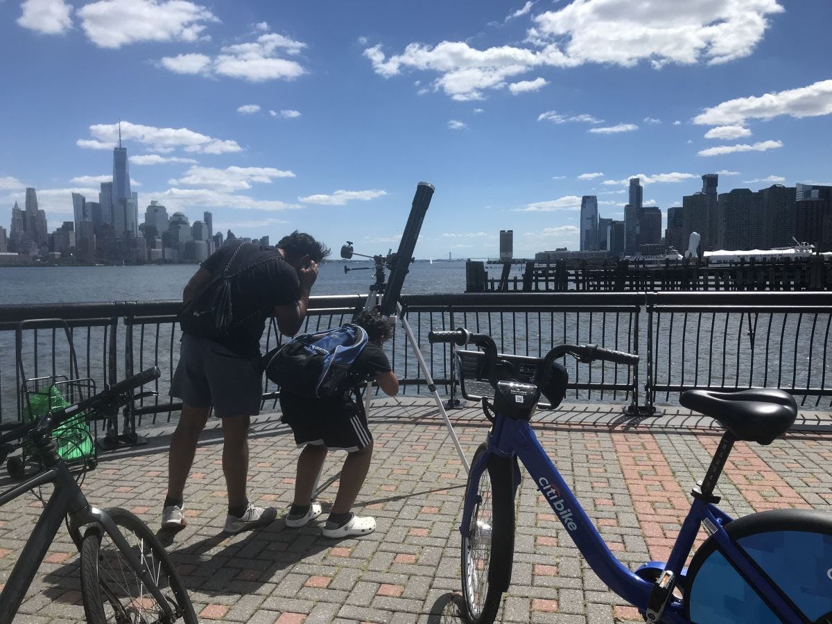 Hoboken residents get curious about physics professor Ting Lu's telescope on the Hudson River pier