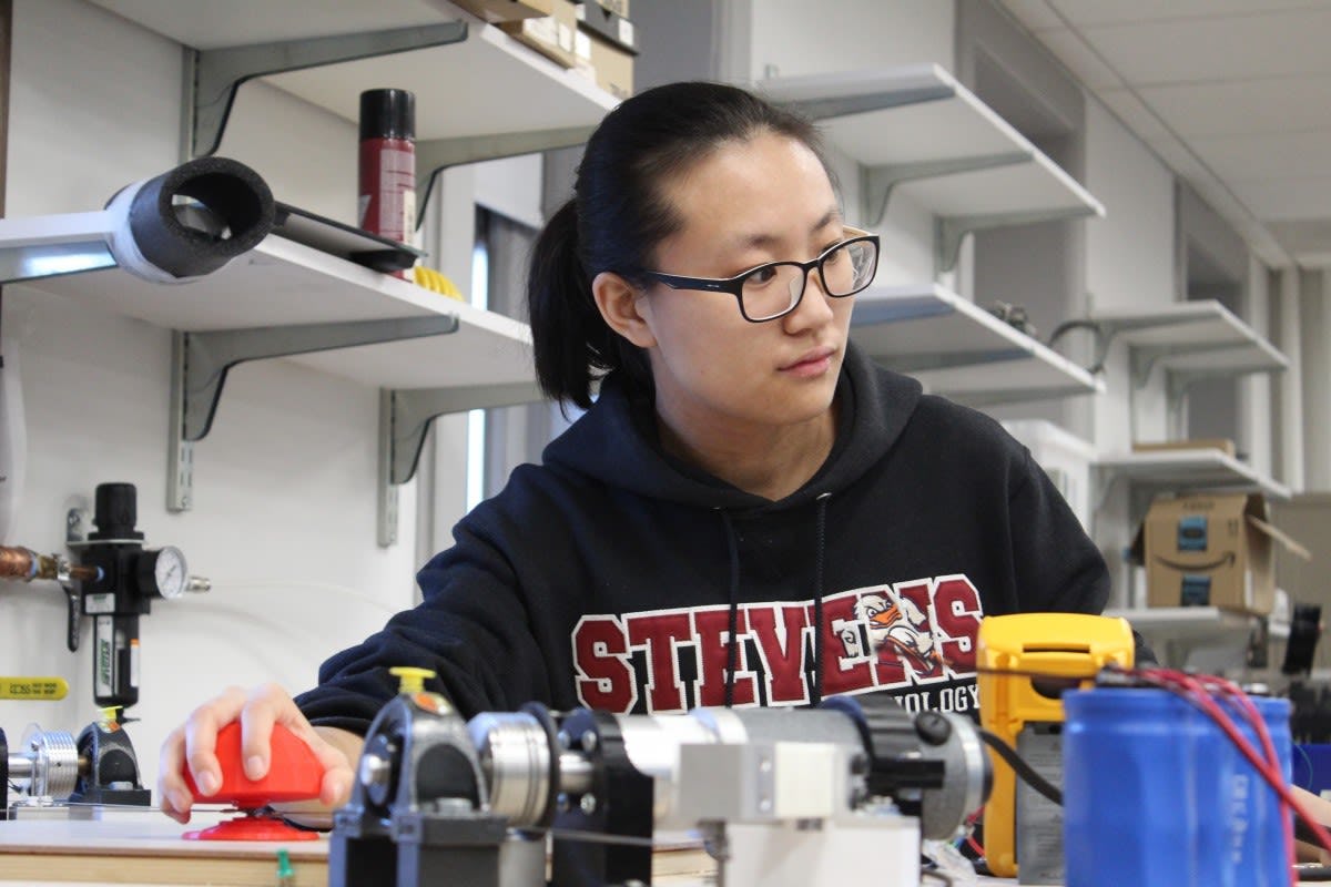 Qianwen Zhao, using her robot-assisted Haptic Joystick therapeutic device in the Wearable Robotic Systems Lab