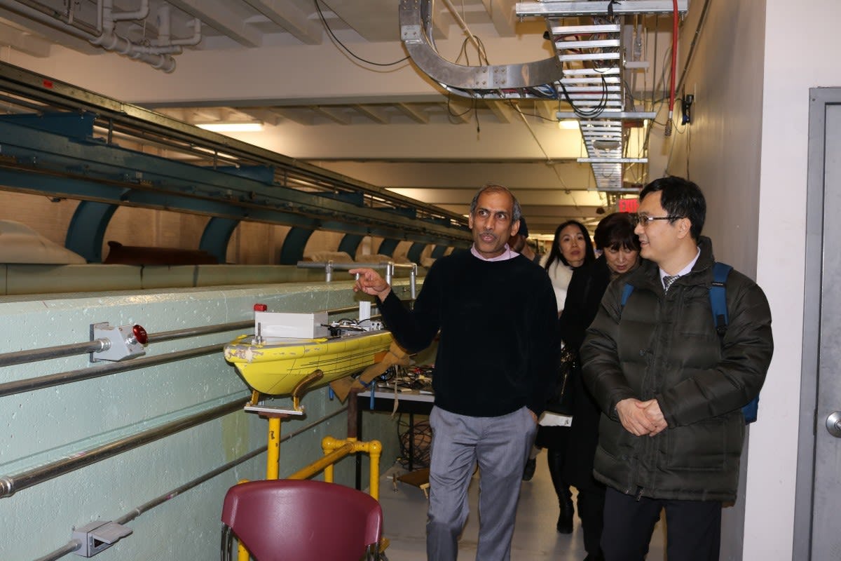 Raju Datla leads Zhang and Song on a tour of the Davidson Lab.