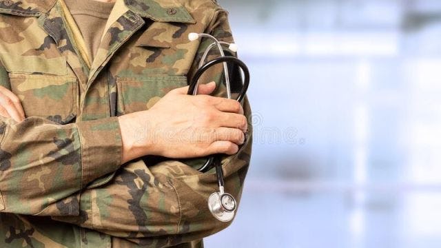 Army solider holding stethoscope