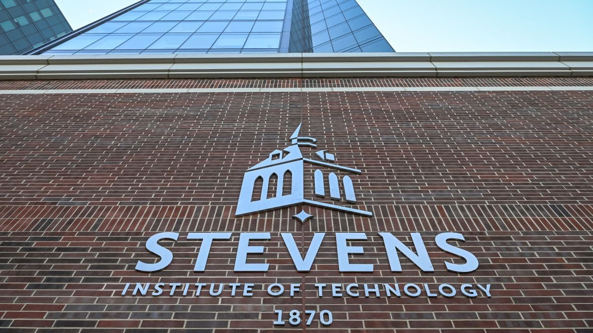 Silver Stevens logo against a brick wall with the residential towers in the background.