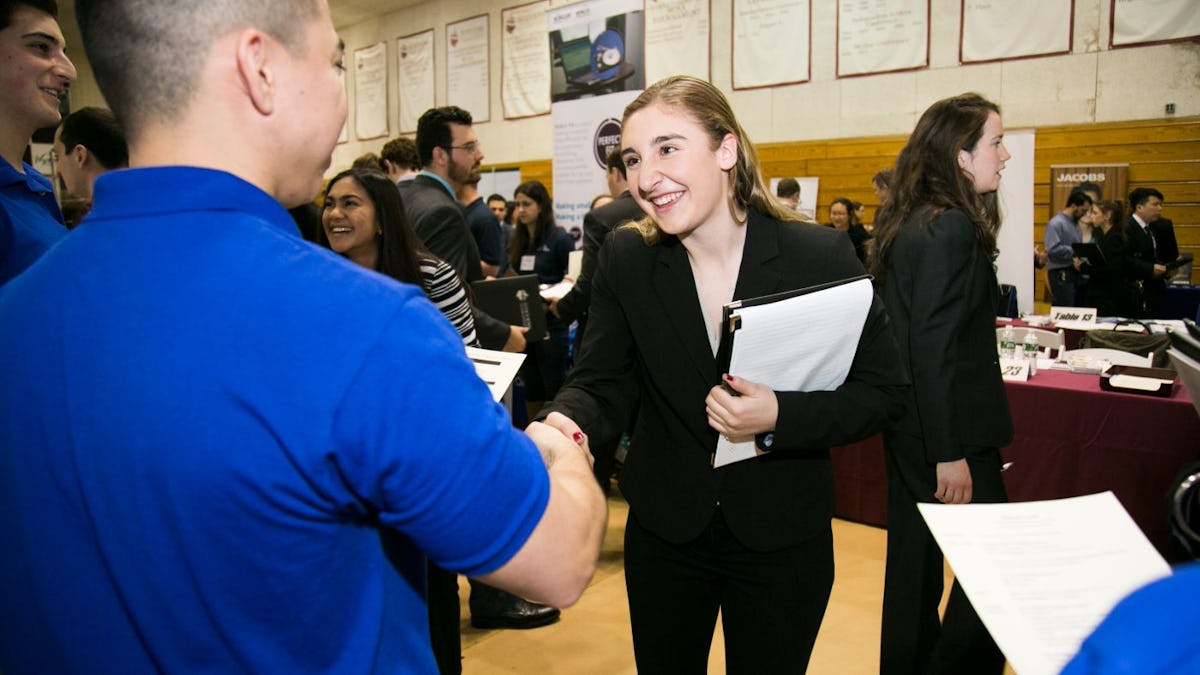 Student shakes hands with recruiter at Career Fair.