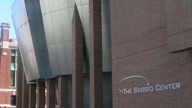 Exterior of the front of The Babbio Center, a modern looking brick building.