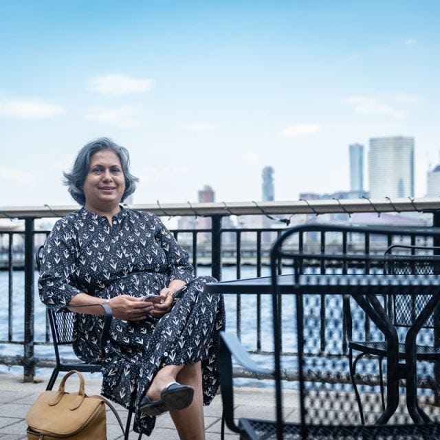 Anagha Yearned sitting on a bench in front of the World Trade Center
