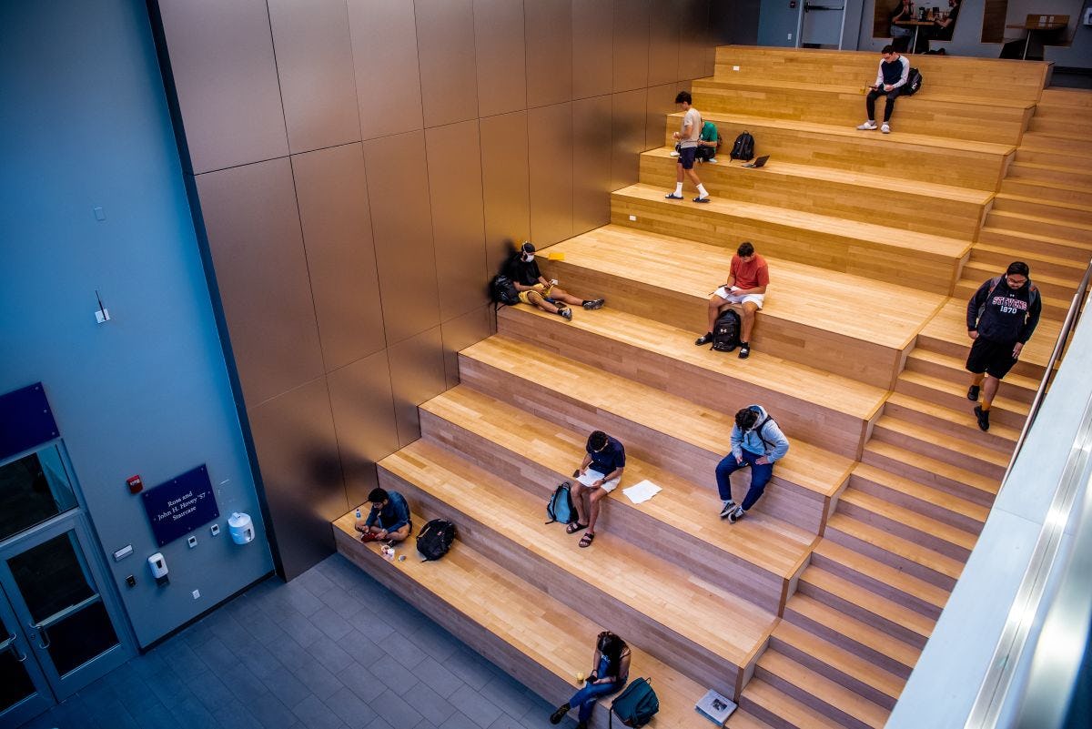 Students study on the inside steps of the Gateway Academic Center