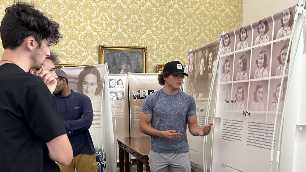 Daniel Yassa '24 gives a tour of the Anne Frank Exhibit in the S.C. Williams Library.