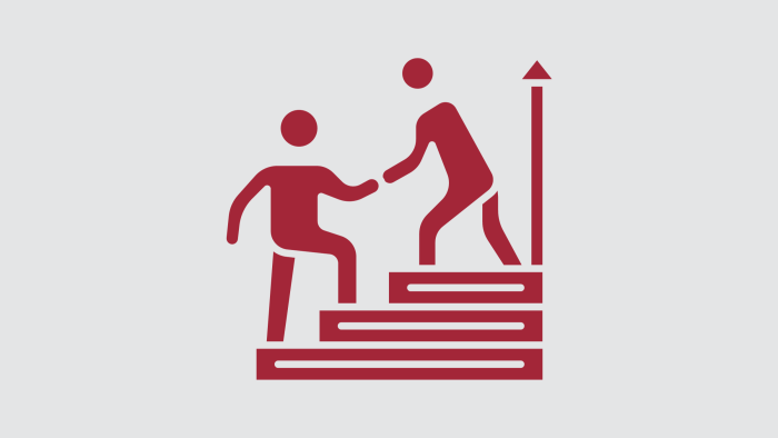 Maroon stick figures help one another climb a set of stairs against a light gray background