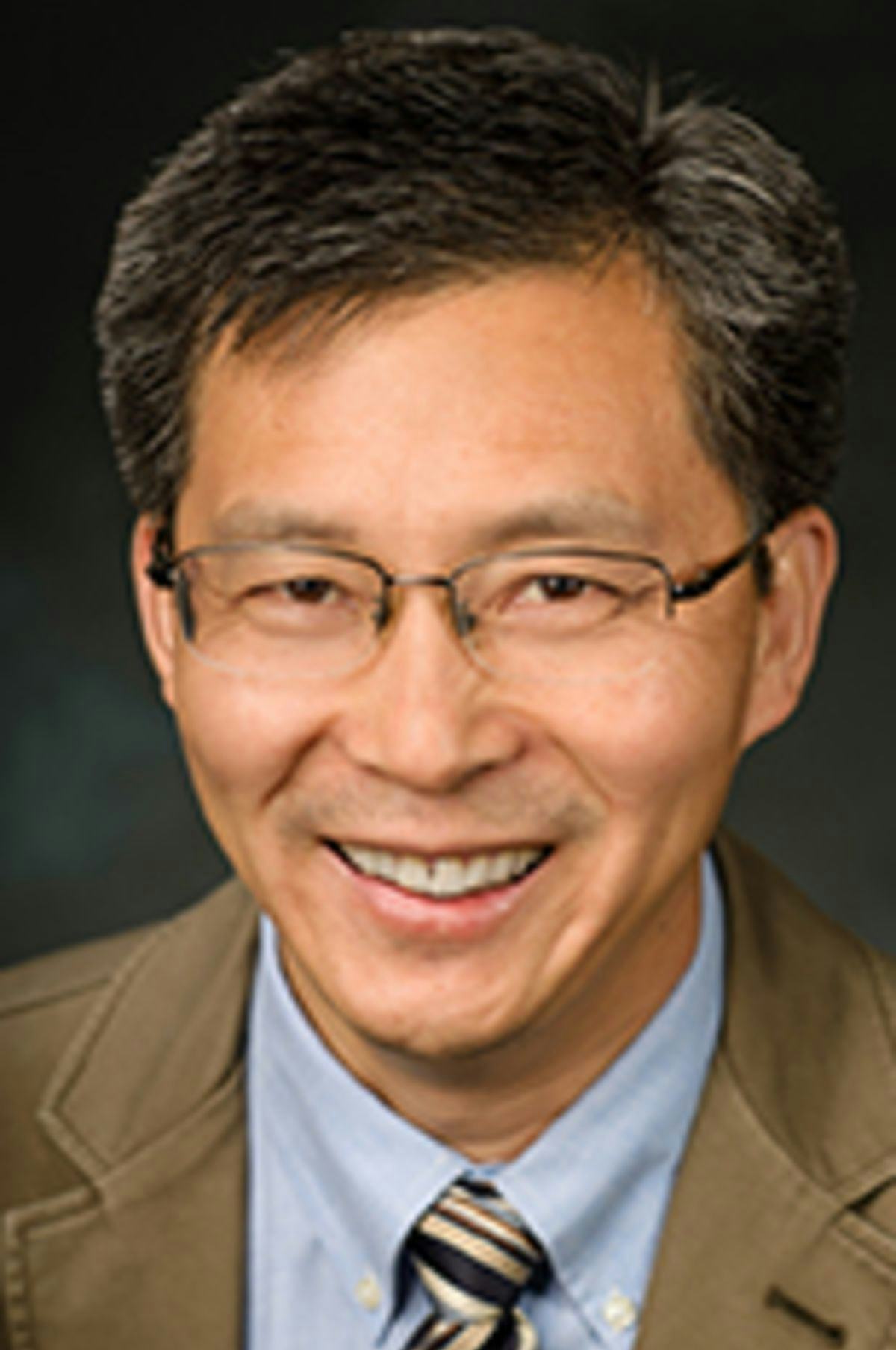 Headshot of Dr. Steve Yang against a black backdrop.