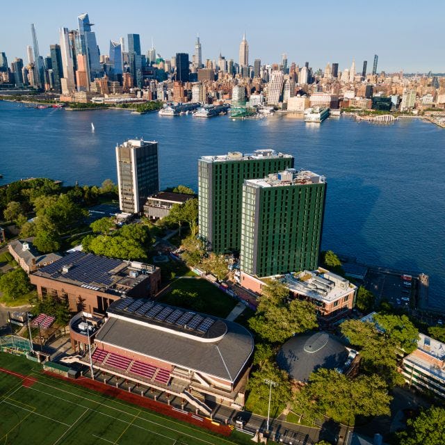 Aerial image of Stevens campus with New York skyline in background.