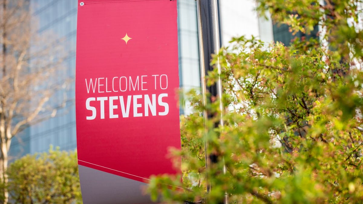 Welcome to Stevens light pole banner with University Center Complex in background