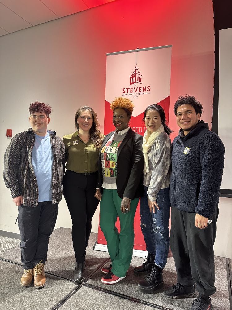 Stevens Director of Diversity, Equity and Inclusion Liliana Delman and keynote speaker Aisha Lawrey '99 pose with students 