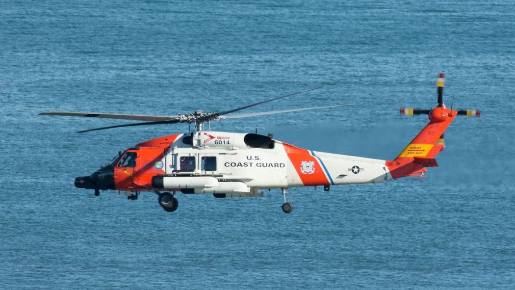 Coast Guard helicopter over ocean