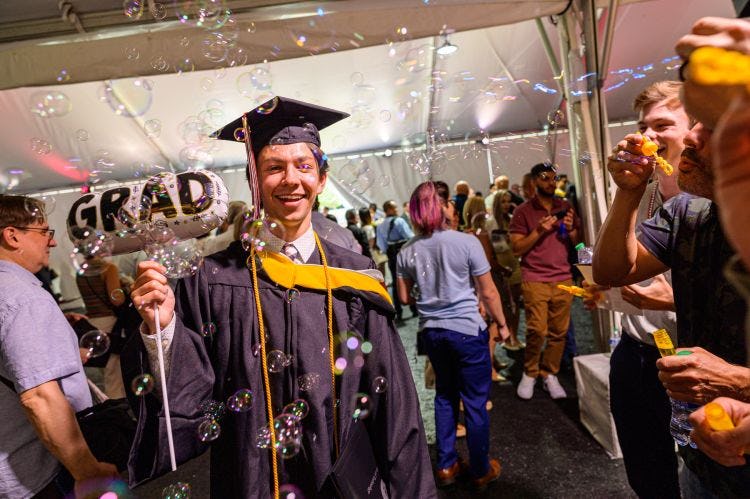 Student celebrates graduation with bubbles 