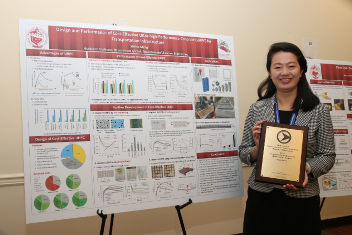 Weina Meng standing in front of a poster at the NJDOT Research Showcase