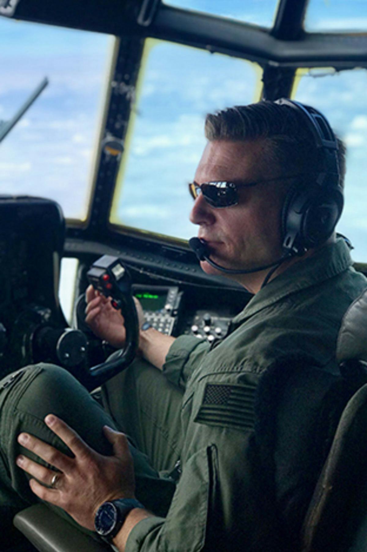 Mark Roberson sitting in the cockpit of a C-130.