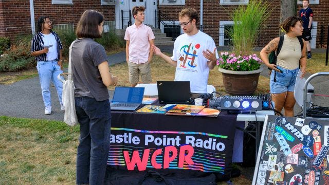 Student speaks at table for WCPR