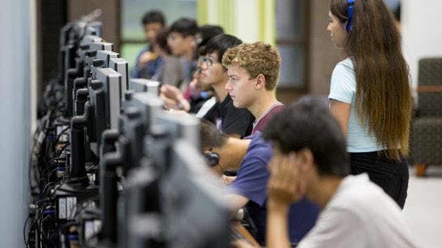 Students in classroom working on computers 