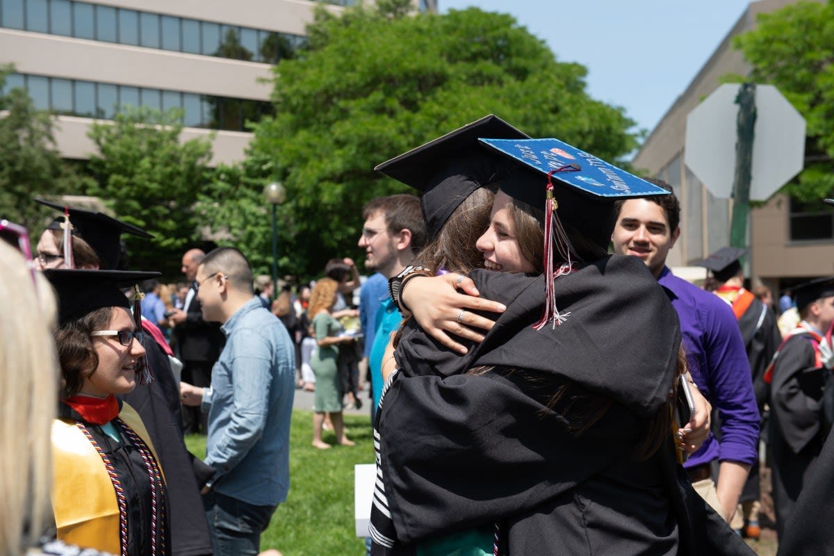 Class of 2019 graduates hugging outside the Meadowlands Expo Center