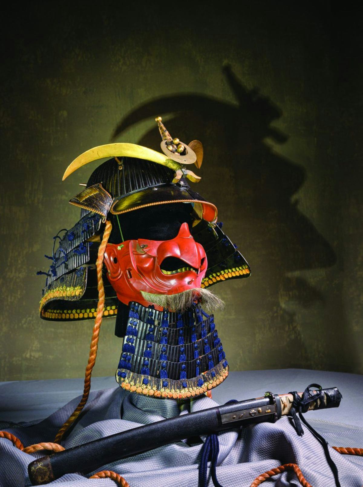 Abe’s gift included many pieces. Shown here are a riveted helmet, mask-like facial armor and a sheathed short sword, known as a wakizashi.