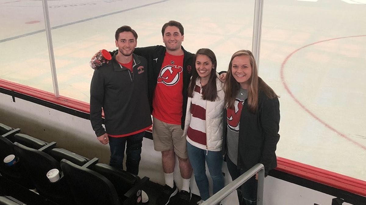 Four Stevens seniors in front of the ice at the Prucential Center in Newark.