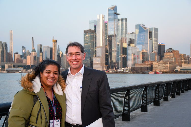 Two CSER 2023 guests posing with New York City skyline in background
