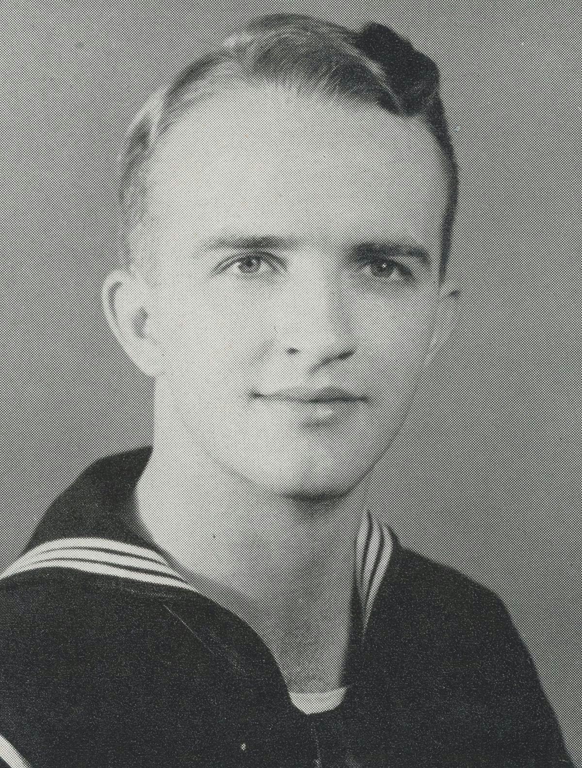 Yearbook portrait of John Schneider in Navy uniform from mid-1940s.