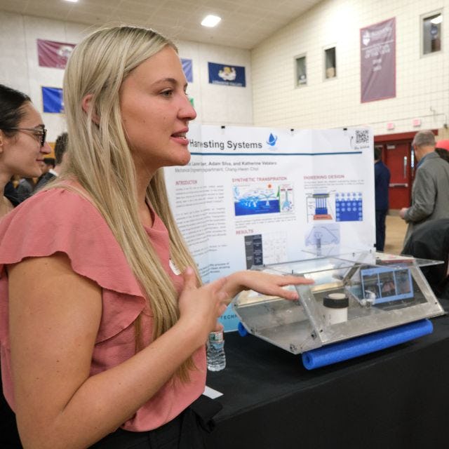 Woman student presents her work at the Innovation Expo