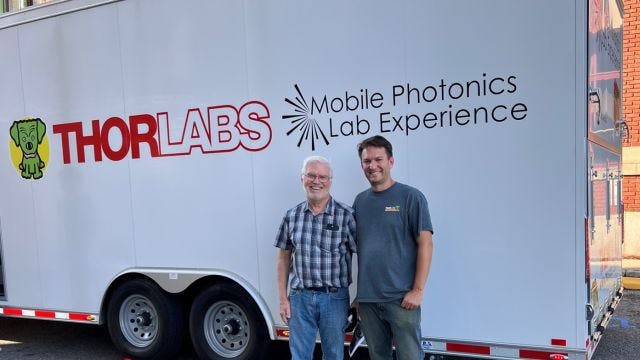 Professor Ed Whittaker and Bill Warger ’03 in front of the Thorlabs Mobile Photonics Lab Experience