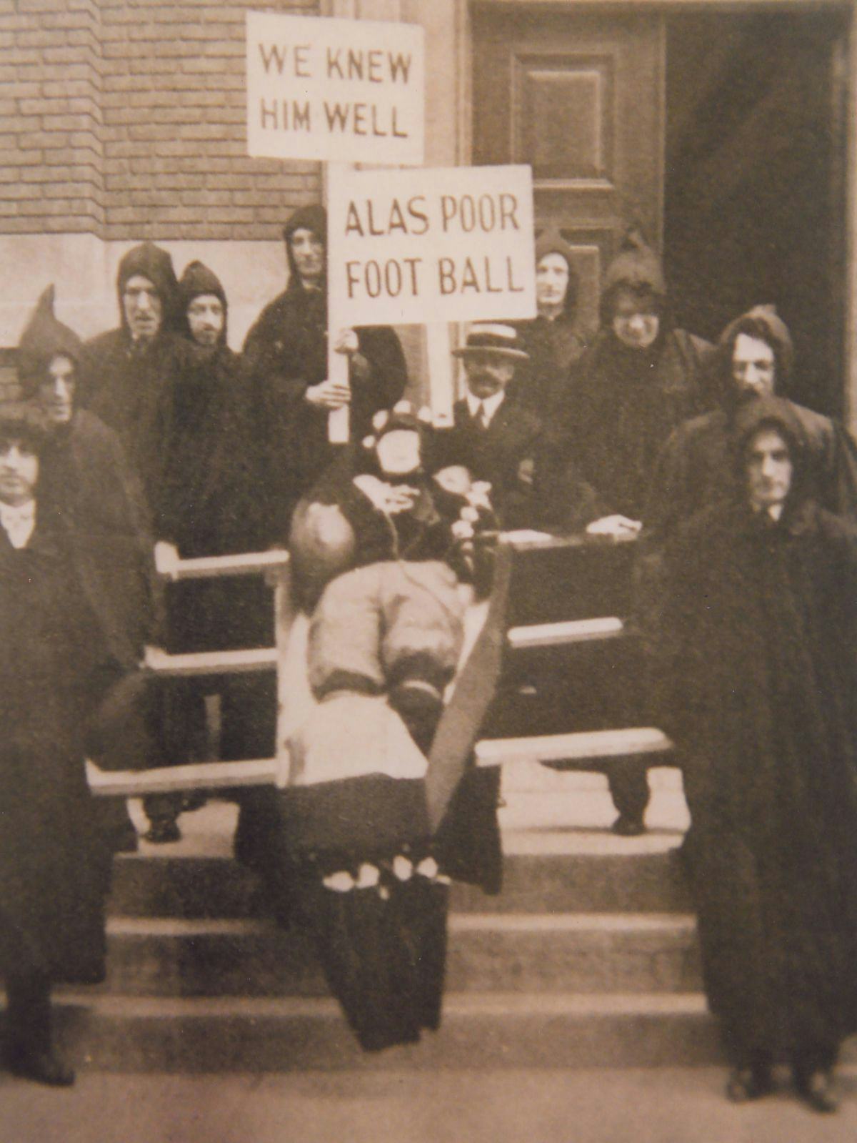 Photo from 1926 of Stevens student carrying a dummy of a deceased football player and signs saying "Alas poor foot ball."