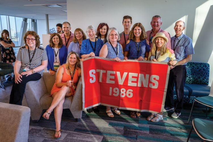 Group of Alumni with sign reading "Stevens 1986".