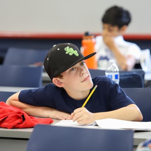 student pondering while taking test at the 2023 Math Olympiad