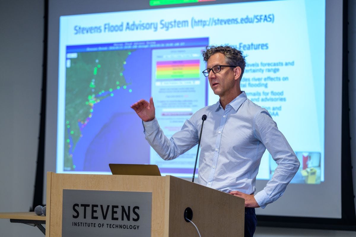 Stevens professor Philip Orton on a stage, presenting at a resilience conference