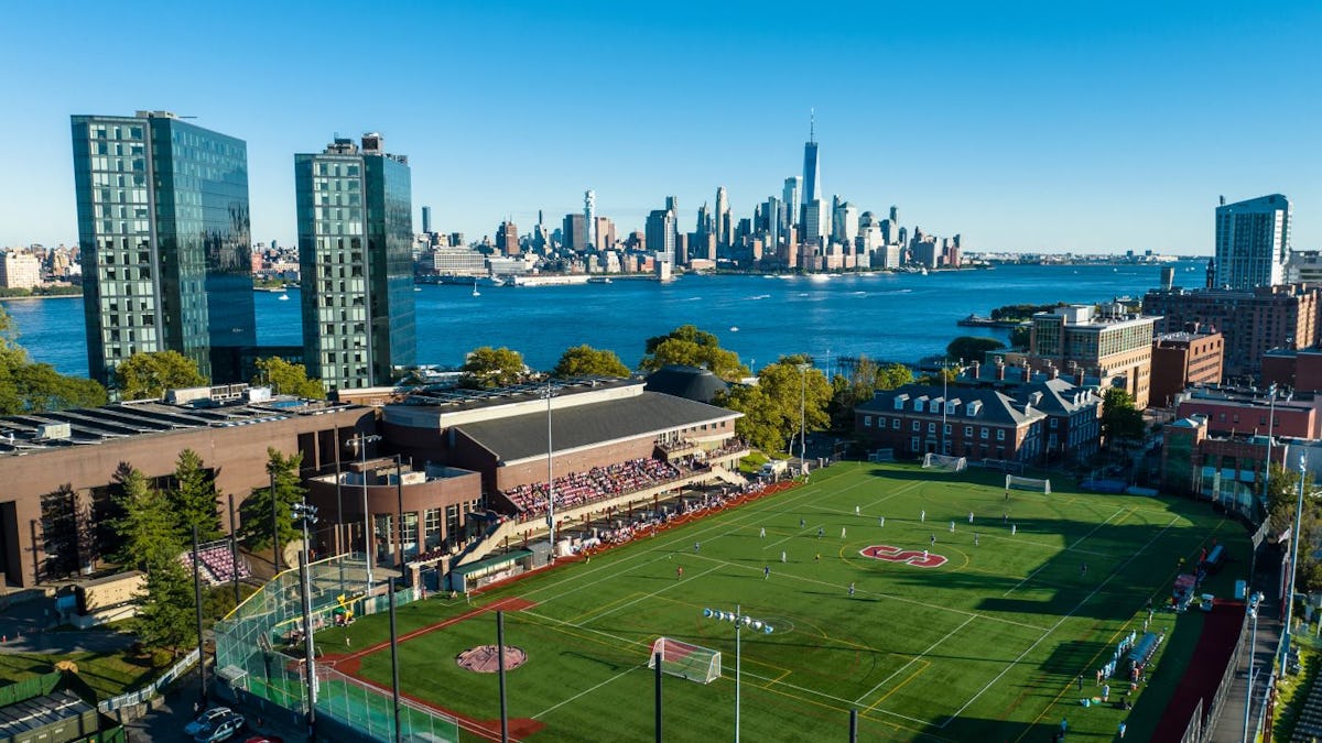 View of Stevens campus from above athletics field, with New York skyline in background