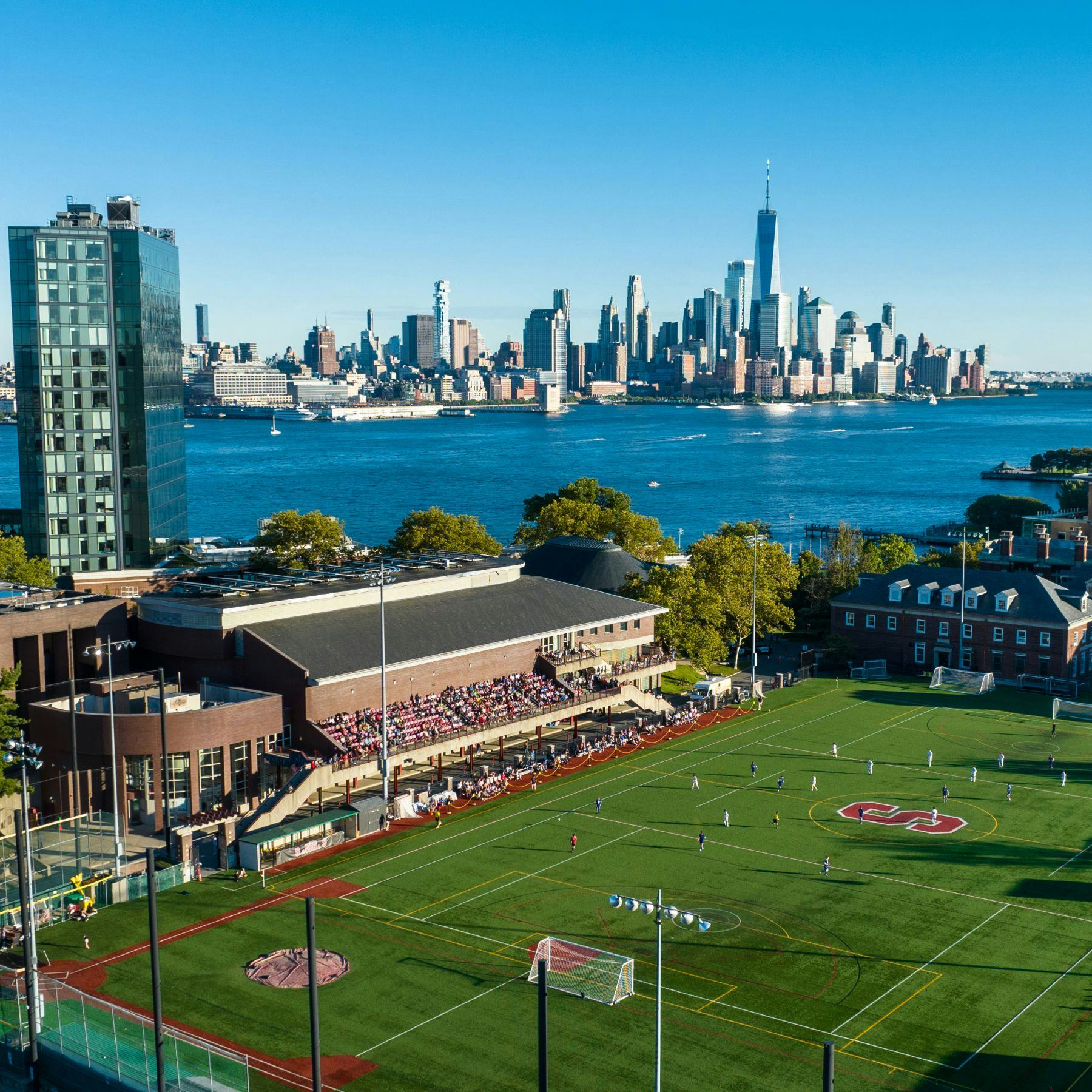 View of Stevens campus from above athletics field, with New York skyline in background