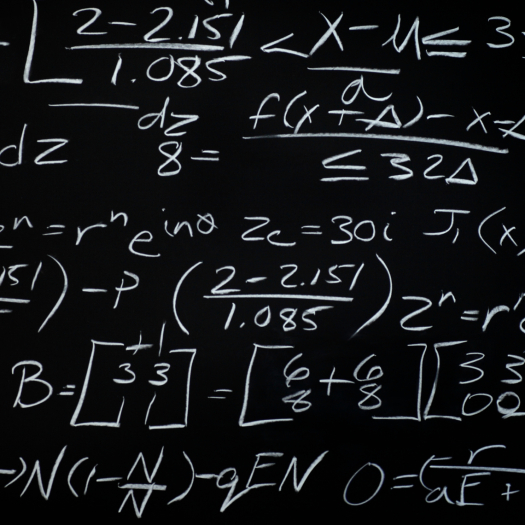 Equations handwritten on blackboard