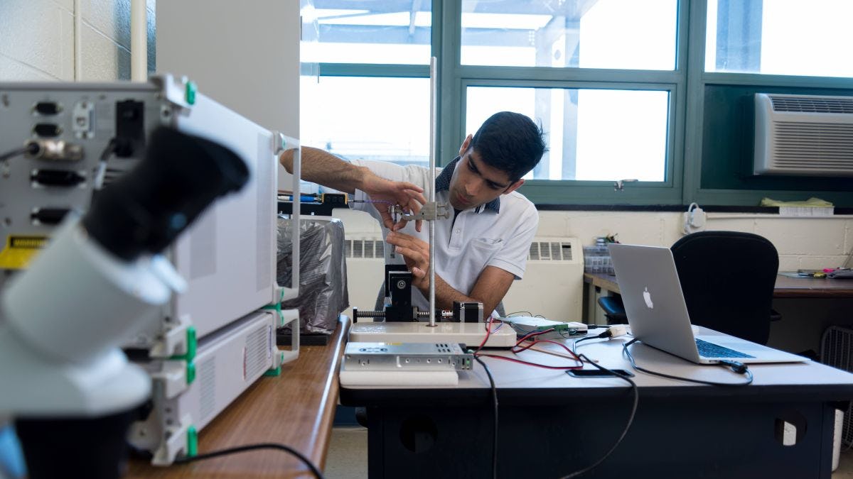Photo of Amir Mirbeik working in the lab