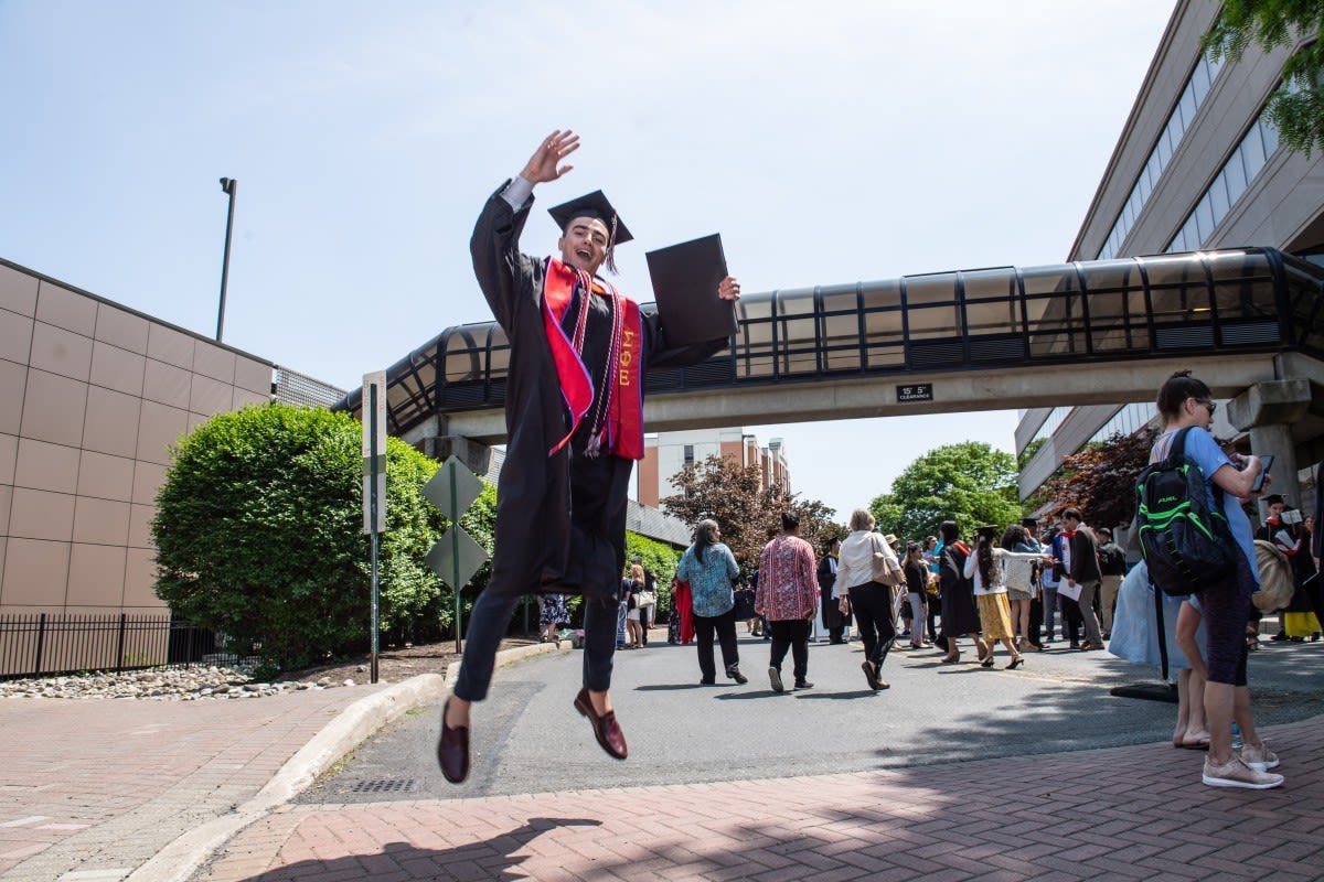 Class of 2019 graduate jumping for joy outside the Meadowlands Expo Center