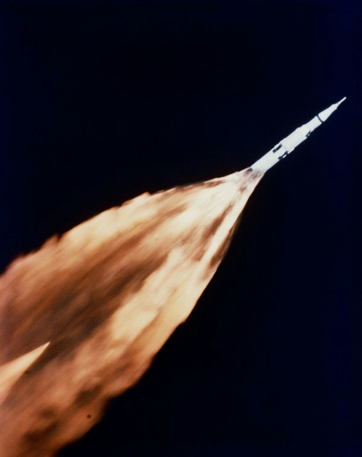 A rocket in space flight with long tail of flames